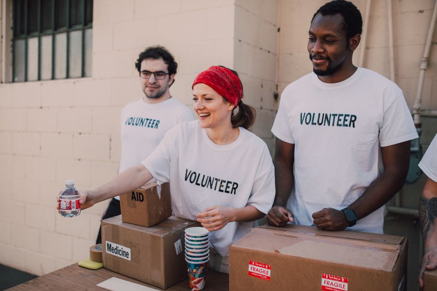 Volunteers handing out supplies at a community donation table
