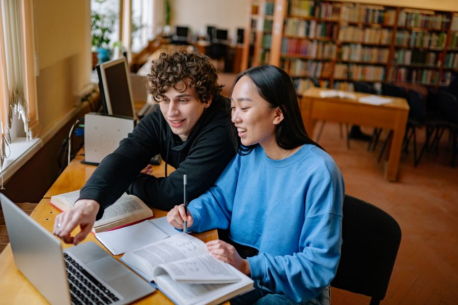 Graduate students studying together in a library